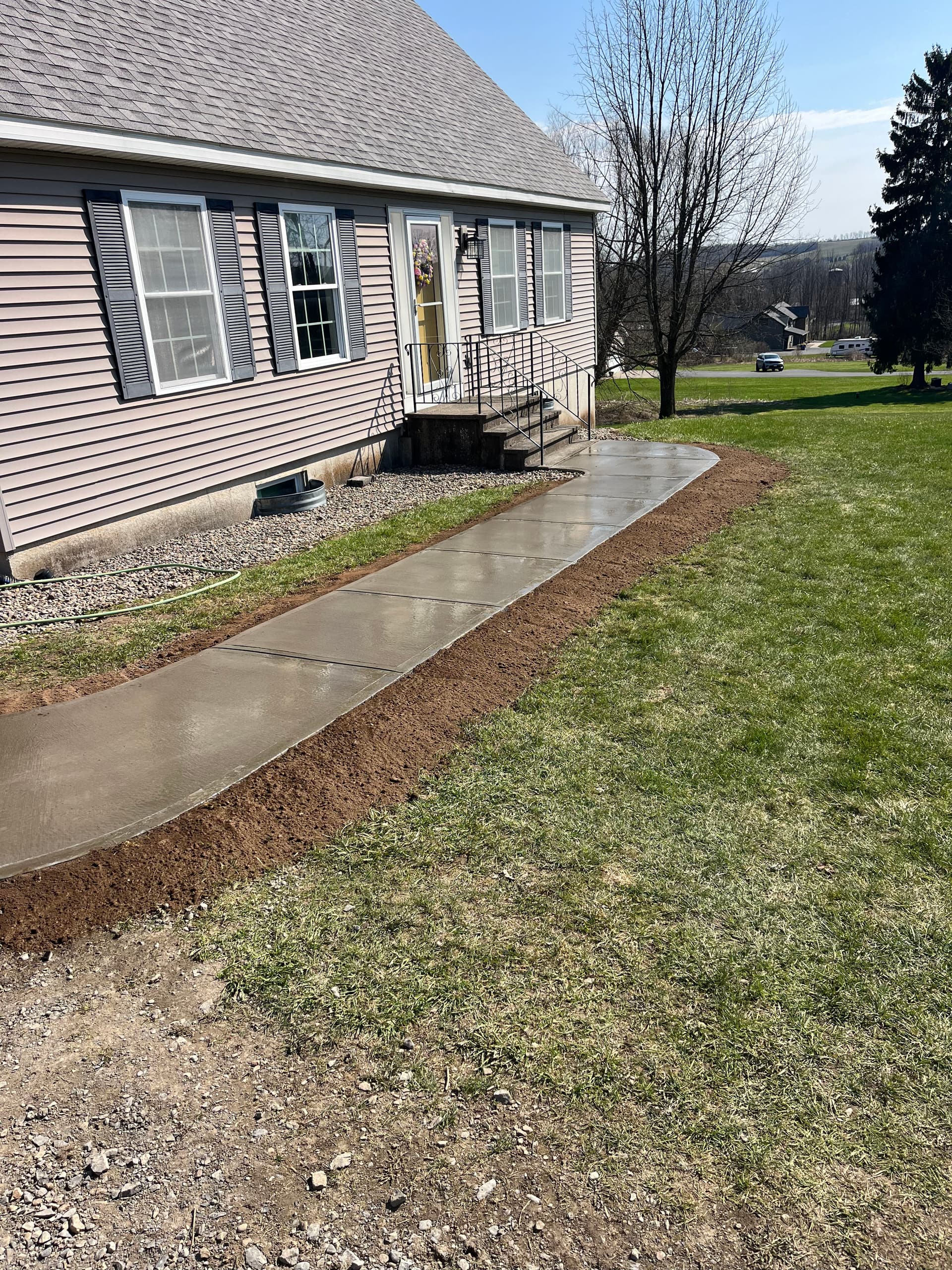 Gallery photos for Muddy Gravel Entrance Gets a Solid Poured Concrete Walkway: Image #1
