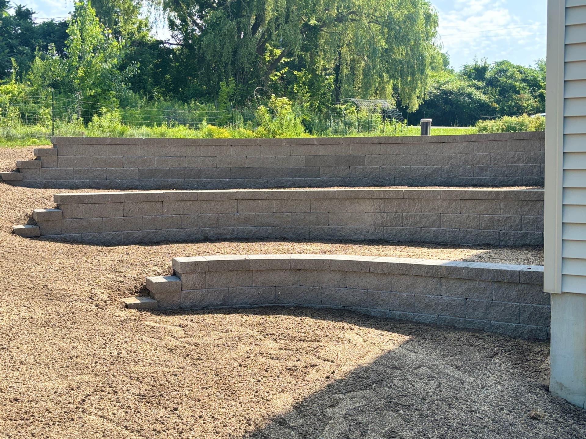 Multi-Tier Versa-Lok Retaining Walls That Put a Sloped Backyard to Work image